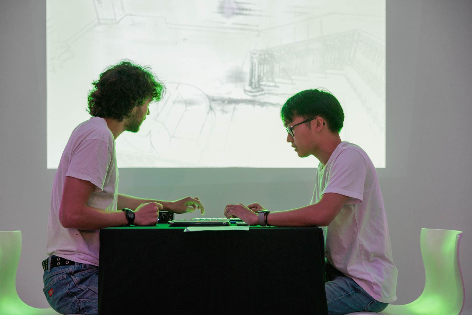 Two young men explore digital art