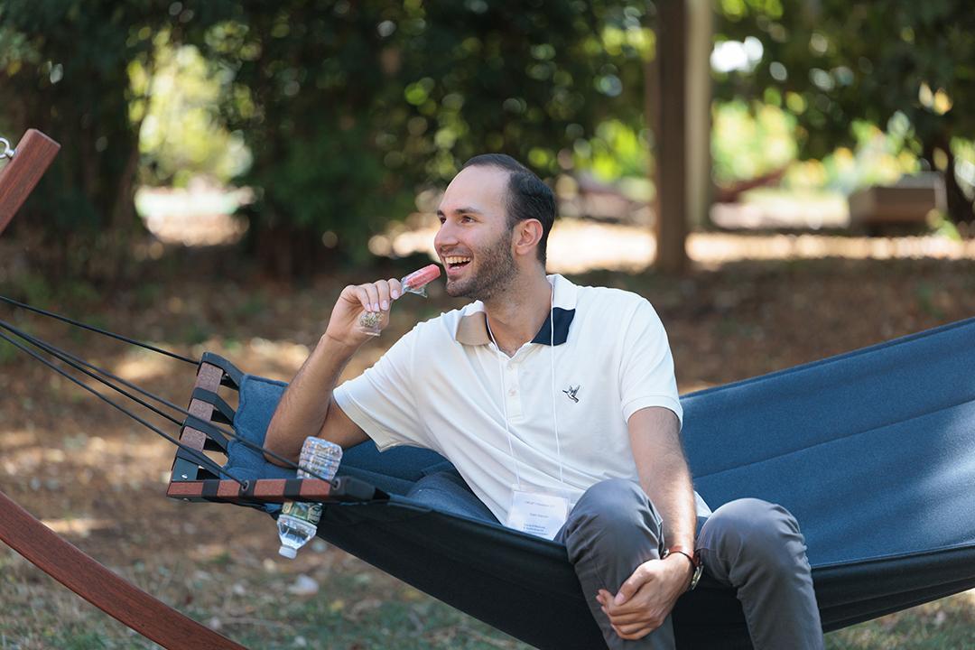 Man sits in a hamock during orientation for physical therapy students