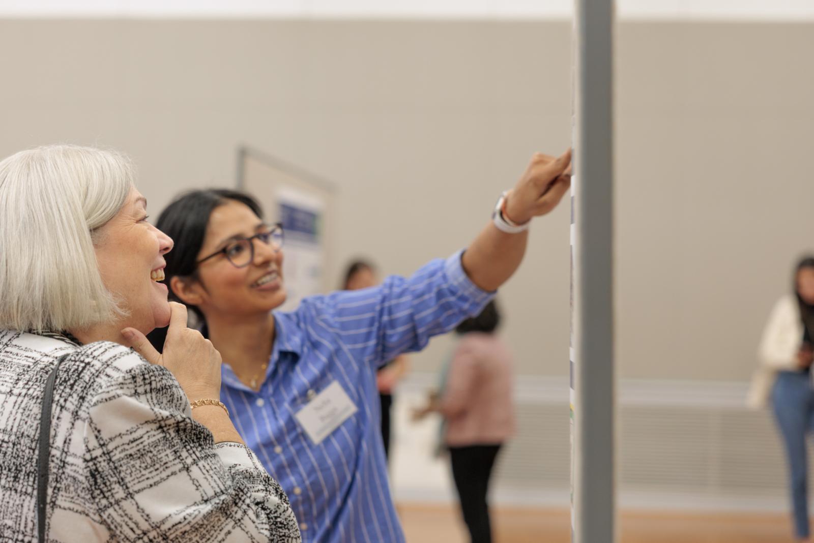 President Granberg visited the poster presentation and spoke with students
