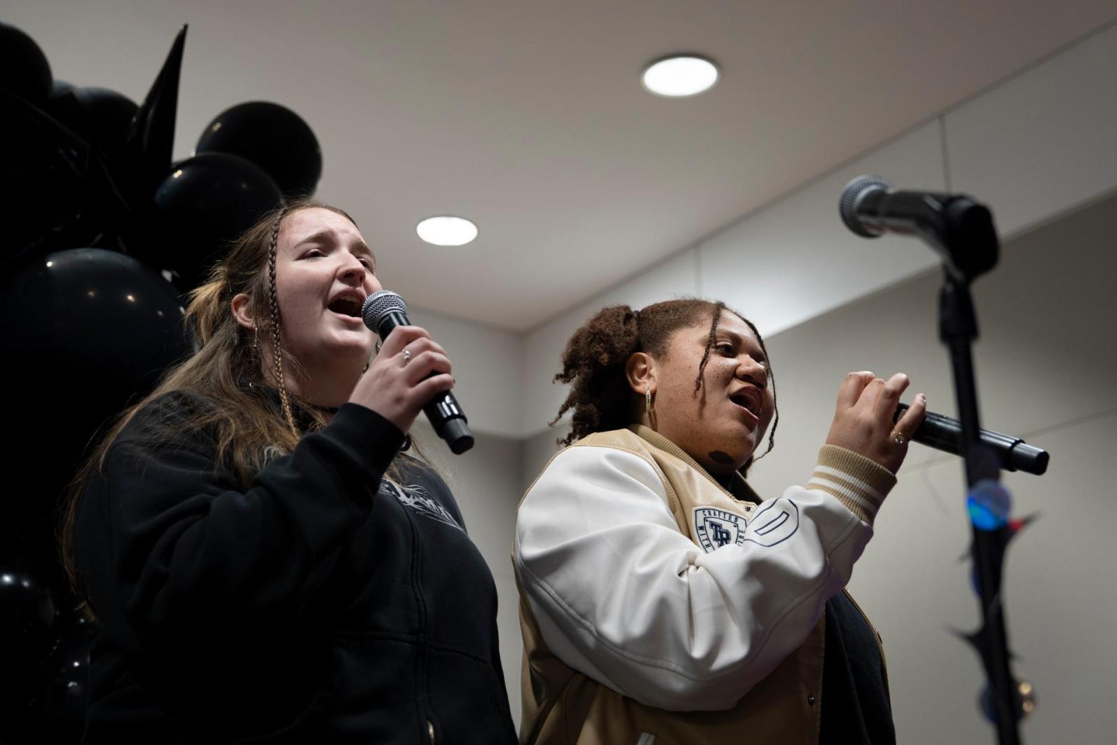 Student singing at Midnight Breakfast