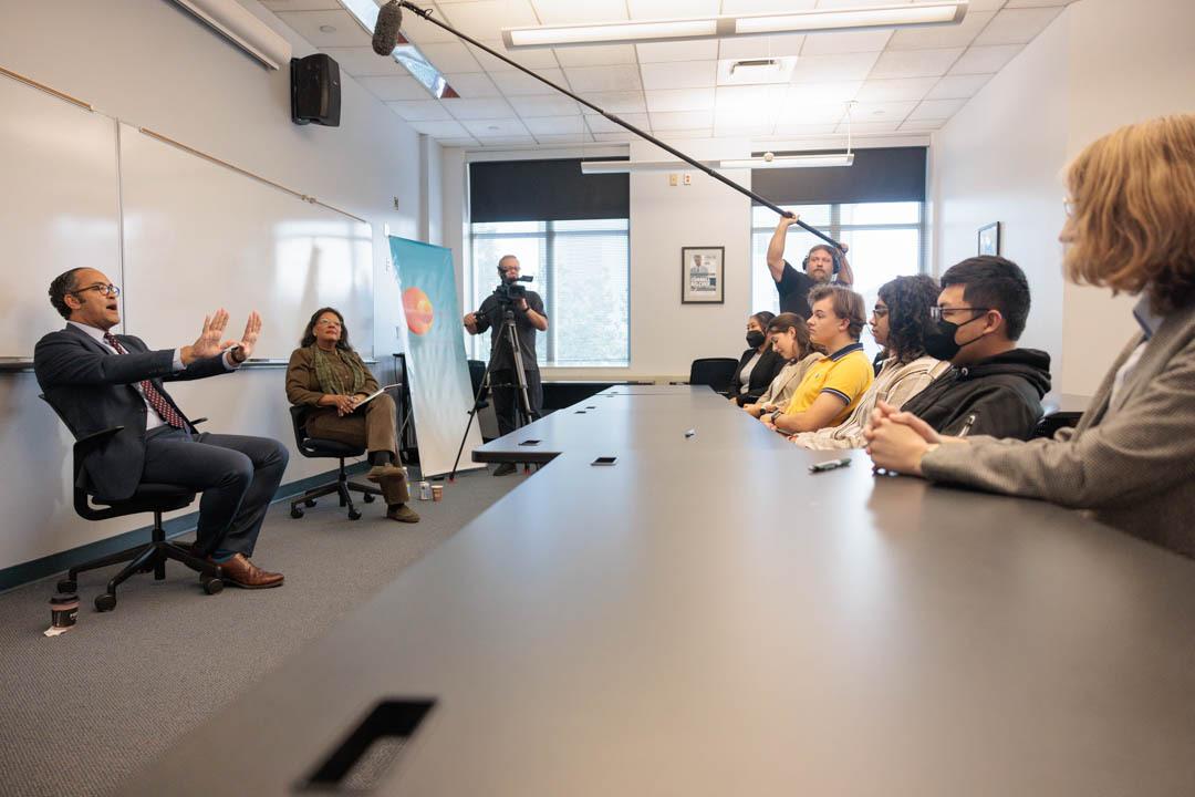 man speaking with students in classroom