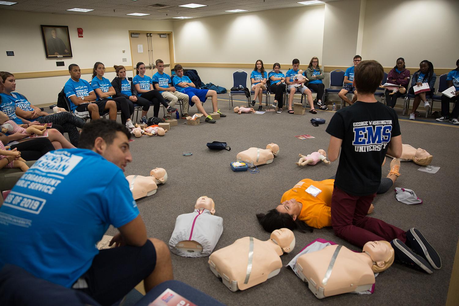 Volunteers learn CPR. (Photo: Zach Marin)