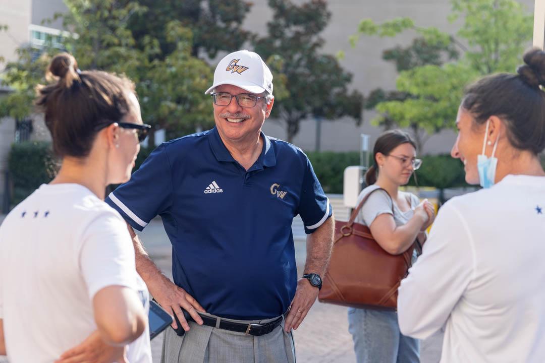 President LeBlanc smiles as he chats with two students