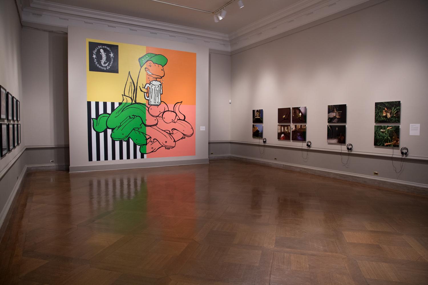 A room at Corcoran's NEXT Exhibition with the walls adorned with student works.