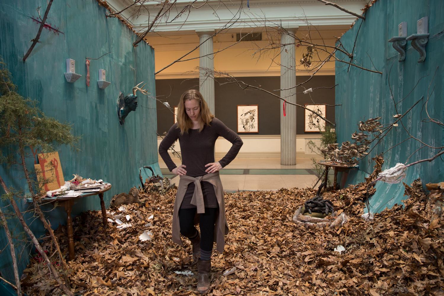 Senior Whitney Waller, stands in her immersive, fall-themed installation, "Dasein."
