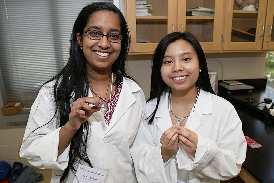 Soumya Chappidi and Tiffany Nguyen, Broad Run High School Students, show off vials filled with their own DNA.