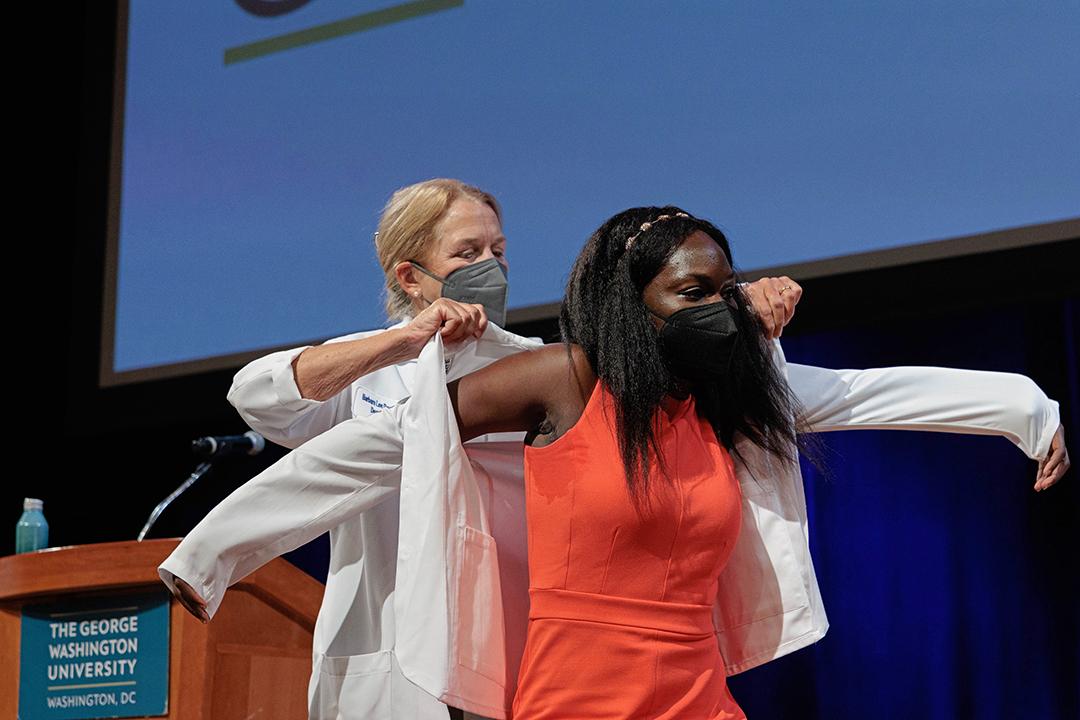 Student receiving white coat