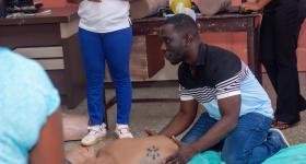 Andrews Nyantakyi demonstrates CPR on a mannequin at a training session organized by his nonprofit Elijeko Foundation. (Courtesy Elijeko Foundation)