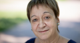 Professor of Physics Chryssa Kouveliotou with short brown hair looking at camera.