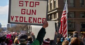 Protester holds "Stop Gun Violence" sign at March for Our Lives (Chip Vincent/Unsplash)
