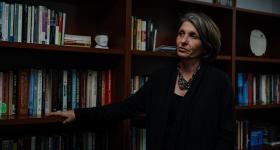 Clinical Psychology Oksana Yakushko in front of a bookself