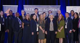 GW President Granberg on a stage with the 12 Flemming Award winners