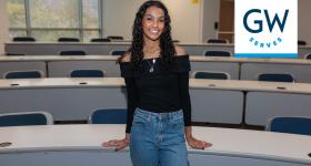Student stands in classroom 