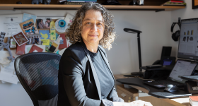 Cognitive Neuroscience Professor Sarah Shomstein at her desk in a grey suit