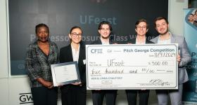 UFeast poses with a check