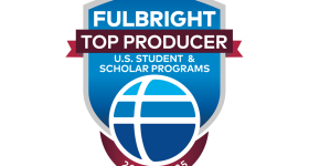 The logo for Fulbright Top Producers. Blue shield with blue globe.