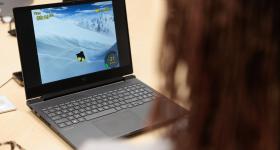 A player uses an EEG headset to control a penguin-racing game. 