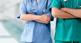Nurses pose in hospital scrubs