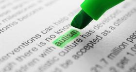A green highlighter underlining the word autism in a text