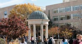 People walk across Kogan Plaza on a sunny fall day